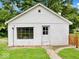 Detached garage with white facade and pathway, offering additional storage and parking at 528 W Mechanic St, Shelbyville, IN 46176