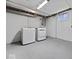 Bright basement laundry room features a white washer and dryer and a concrete floor at 528 W Mechanic St, Shelbyville, IN 46176