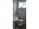 The bathroom features a white sink and toilet, set against gray walls and a window at 5344 Fletcher Ave, Indianapolis, IN 46219