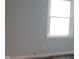 The bedroom features a bright window, casting light onto the gray walls at 5344 Fletcher Ave, Indianapolis, IN 46219