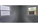 The bedroom has gray walls, and two windows, one with an air conditioner at 5344 Fletcher Ave, Indianapolis, IN 46219