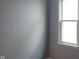 The bedroom has gray walls and a bright window, providing natural light at 5344 Fletcher Ave, Indianapolis, IN 46219