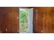 Interior view showing wood paneled room with open door to backyard with foliage and fence at 5344 Fletcher Ave, Indianapolis, IN 46219