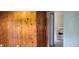 The house has wood paneling and a view into the kitchen, which has white appliances at 5344 Fletcher Ave, Indianapolis, IN 46219