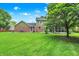 Spacious backyard featuring a lush lawn, mature trees, and a charming screened-in porch, perfect for relaxation and outdoor enjoyment at 58 Penn Pl, Zionsville, IN 46077
