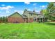 Expansive backyard featuring a well-maintained lawn, mature trees, and a screened-in porch, perfect for outdoor activities at 58 Penn Pl, Zionsville, IN 46077