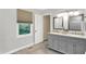 Bathroom featuring a window with blinds, a double vanity, and marble countertops at 58 Penn Pl, Zionsville, IN 46077