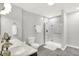 Bright bathroom featuring a double vanity with marble countertop and a glass-enclosed shower with marble-tile surround at 58 Penn Pl, Zionsville, IN 46077