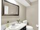 Cozy half-bathroom features a decorative mirror, white tile countertop, and a white toilet at 58 Penn Pl, Zionsville, IN 46077