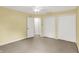 Upstairs bedroom with yellow walls, carpeted floors, ceiling fan, and closet space at 58 Penn Pl, Zionsville, IN 46077