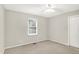 Bright bedroom features neutral walls, carpeted floors, a window with blinds, ceiling fan, and closet at 58 Penn Pl, Zionsville, IN 46077