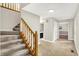 The foyer features a wooden staircase, beige walls, and an eye-catching tile floor at 58 Penn Pl, Zionsville, IN 46077