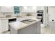 Updated kitchen featuring stainless steel appliances, tile countertops, and a functional island cooktop at 58 Penn Pl, Zionsville, IN 46077