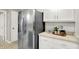 Kitchen featuring stainless steel refrigerator and white cabinets with plenty of countertop space at 58 Penn Pl, Zionsville, IN 46077
