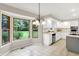 Sunny kitchen features white cabinets, tile flooring, plenty of counter space, and a large bay window at 58 Penn Pl, Zionsville, IN 46077