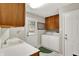 Bright laundry room features a sink, plenty of cabinet space, washer and dryer, and access to the backyard at 58 Penn Pl, Zionsville, IN 46077