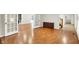 Bright living room with wood flooring, leading to multiple rooms and offering versatile living spaces at 58 Penn Pl, Zionsville, IN 46077