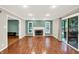 Formal living room with hardwood flooring, fireplace, recessed lighting and a sliding door to the outside at 58 Penn Pl, Zionsville, IN 46077