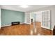 Spacious living room featuring hardwood floors, a bench, and a partial view into another room with fireplace at 58 Penn Pl, Zionsville, IN 46077