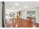 Spacious living room with hardwood flooring and a view to the updated kitchen and built-in desk area at 58 Penn Pl, Zionsville, IN 46077