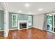 Comfortable living room with hardwood flooring, a fireplace, recessed lighting and a door to the outside at 58 Penn Pl, Zionsville, IN 46077