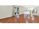 Open concept living room with hardwood flooring and a view to the kitchen and walk-out to the back deck at 58 Penn Pl, Zionsville, IN 46077