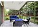 Bright screened-in sunroom with comfortable seating, offering a great space for relaxation and enjoyment of the outdoors at 58 Penn Pl, Zionsville, IN 46077