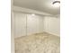 Finished basement with neutral carpet and multiple doors at 602 S Sherman Dr, Indianapolis, IN 46203