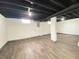Unfinished basement with painted ceiling and wood look floor at 602 S Sherman Dr, Indianapolis, IN 46203