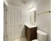 Updated bathroom with single sink vanity, gold fixtures, and a toilet on marble-look tile floor at 602 S Sherman Dr, Indianapolis, IN 46203
