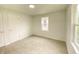 Clean bedroom offers natural light, neutral walls, and plush carpeting at 602 S Sherman Dr, Indianapolis, IN 46203