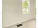 Bright bedroom features neutral walls, cozy carpet, and a window view of mature tree at 602 S Sherman Dr, Indianapolis, IN 46203