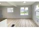 Open living area with new vinyl floors, big windows allowing lots of natural light, and neutral paint at 602 S Sherman Dr, Indianapolis, IN 46203