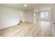 Spacious living area with wood-look flooring, freshly painted walls, and plenty of natural light at 602 S Sherman Dr, Indianapolis, IN 46203