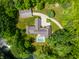 Aerial view of a luxury home with a pool, surrounded by lush trees creating a private oasis at 6115 Stonegate Run, Zionsville, IN 46077