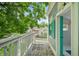 Exterior balcony of a playhouse with green trim overlooking the roof of a modern home and green grass at 6115 Stonegate Run, Zionsville, IN 46077