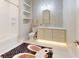 Charming bathroom features a tub, vanity with mosaic backsplash, and built-in shelves at 6115 Stonegate Run, Zionsville, IN 46077
