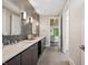 Modern bathroom boasts a dual sink vanity, gray subway tile accent wall, and an open doorway to an adjacent room at 6115 Stonegate Run, Zionsville, IN 46077