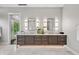 Elegant bathroom with double vanity, modern lighting, marble floors, and a view of the outdoor scenery at 6115 Stonegate Run, Zionsville, IN 46077