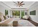 Bright bedroom with a ceiling fan, hardwood floors and sliding glass doors overlooking a pool at 6115 Stonegate Run, Zionsville, IN 46077