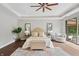 Bright bedroom featuring hardwood floors, stylish lamps and mirrors on either side of the king bed at 6115 Stonegate Run, Zionsville, IN 46077