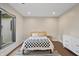 Bright bedroom with hardwood floors, a black and white rug, a modern bed frame, and lots of natural light at 6115 Stonegate Run, Zionsville, IN 46077