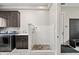 This laundry room features a convenient dog wash station, laundry sink, and plenty of cabinet space at 6115 Stonegate Run, Zionsville, IN 46077