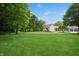 Well-maintained front yard featuring a sprawling lawn, modern home, detached garage and mature shade trees at 6115 Stonegate Run, Zionsville, IN 46077