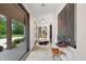 Long hallway with modern lighting and decor offers a glimpse of the outdoors through a large window at 6115 Stonegate Run, Zionsville, IN 46077