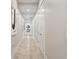 Bright hallway featuring neutral walls, modern art, recessed lighting, and tile flooring at 6115 Stonegate Run, Zionsville, IN 46077