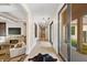 Bright hallway featuring tile floors, modern light fixtures, and a seamless transition to the outdoor patio at 6115 Stonegate Run, Zionsville, IN 46077