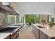 Gourmet kitchen featuring stainless steel appliances and large island with countertops overlooking the fireplace at 6115 Stonegate Run, Zionsville, IN 46077