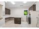 Spacious laundry room with custom cabinetry, countertop space, modern appliances, and a convenient shower area at 6115 Stonegate Run, Zionsville, IN 46077
