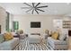 Comfortable living room featuring modern decor and a unique ceiling fan creating a welcoming atmosphere at 6115 Stonegate Run, Zionsville, IN 46077